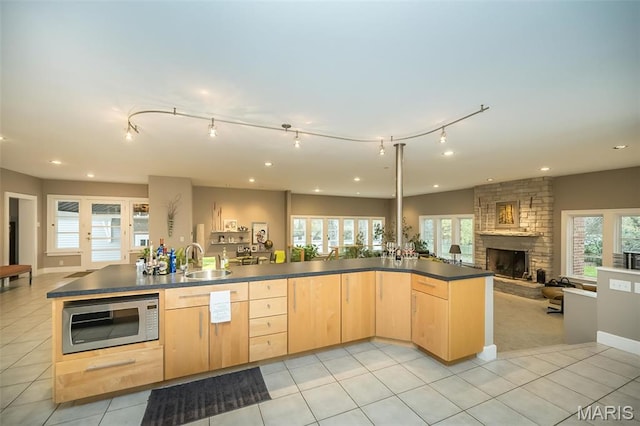 1211 S Geyer Rd, Saint Louis, MO 63122 - kitchen with light brown cabinetry, stainless steel microwave, open floor plan, a sink, and track lighting