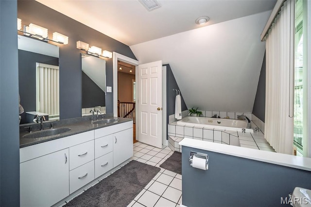 1211 S Geyer Rd, Saint Louis, MO 63122 - bathroom with lofted ceiling, double vanity, a whirlpool tub, and tile patterned flooring