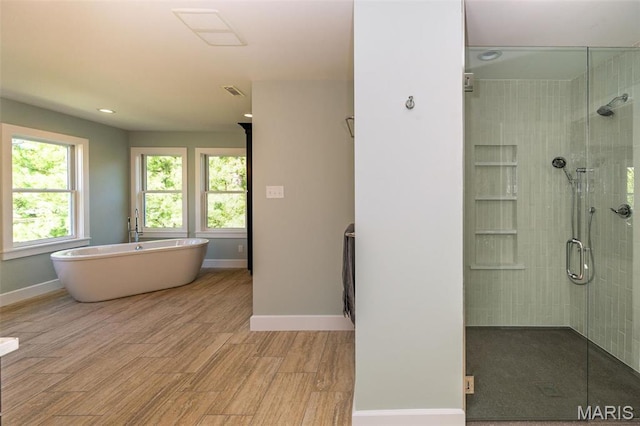 1211 S Geyer Rd, Saint Louis, MO 63122 - full bathroom with a shower stall, baseboards, wood finished floors, a soaking tub, and recessed lighting