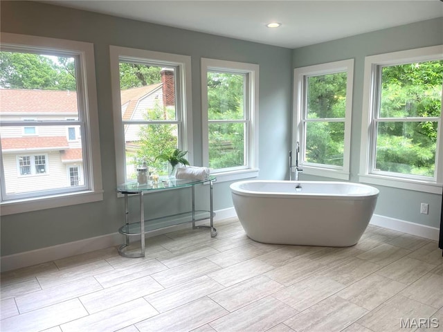 1211 S Geyer Rd, Saint Louis, MO 63122 - full bath with a freestanding tub, wood tiled floors, and baseboards