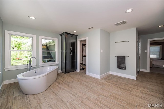1211 S Geyer Rd, Saint Louis, MO 63122 - full bathroom with a soaking tub, baseboards, recessed lighting, a spacious closet, and wood finished floors