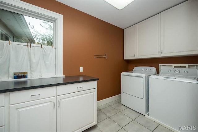 1211 S Geyer Rd, Saint Louis, MO 63122 - laundry room with cabinet space, washer and clothes dryer, baseboards, and light tile patterned floors