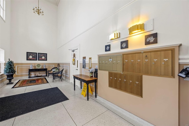 welcome area with a towering ceiling and mail area
