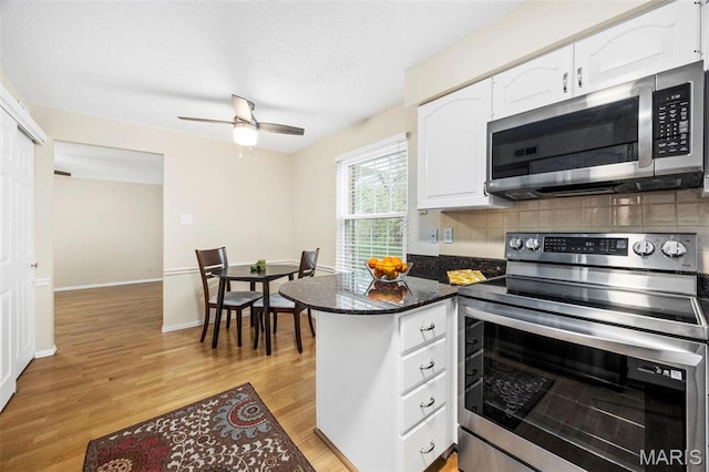 15038 Claymoor Ct Unit 2, Chesterfield, MO 63017 - kitchen with appliances with stainless steel finishes, white cabinets, light wood-style floors, a peninsula, and backsplash