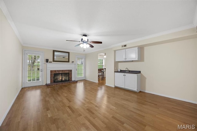15038 Claymoor Ct Unit 2, Chesterfield, MO 63017 - unfurnished living room with a ceiling fan, light wood-style flooring, baseboards, crown molding, and a sink
