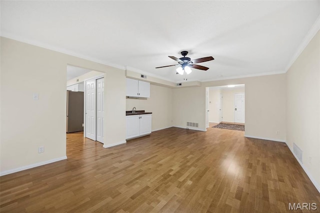 15038 Claymoor Ct Unit 2, Chesterfield, MO 63017 - unfurnished living room with a ceiling fan, light wood-type flooring, crown molding, baseboards, and a sink