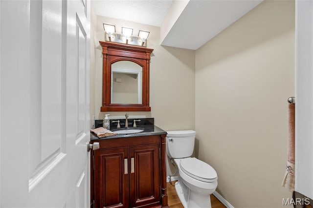 15038 Claymoor Ct Unit 2, Chesterfield, MO 63017 - bathroom with toilet, vanity, wood finished floors, and baseboards