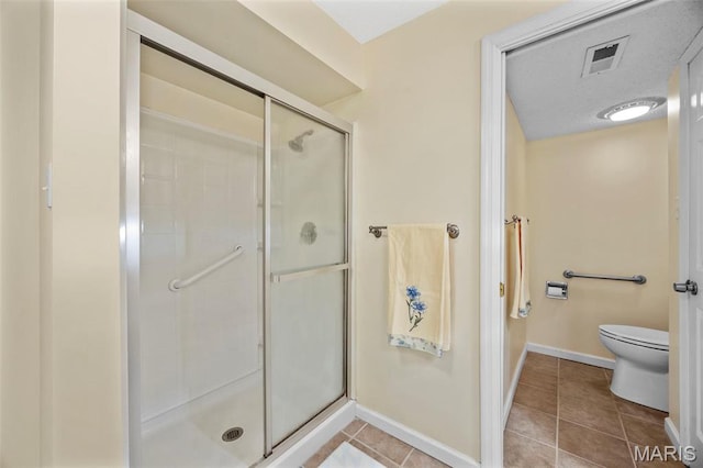 15038 Claymoor Ct Unit 2, Chesterfield, MO 63017 - full bath with a shower stall, toilet, tile patterned floors, and baseboards