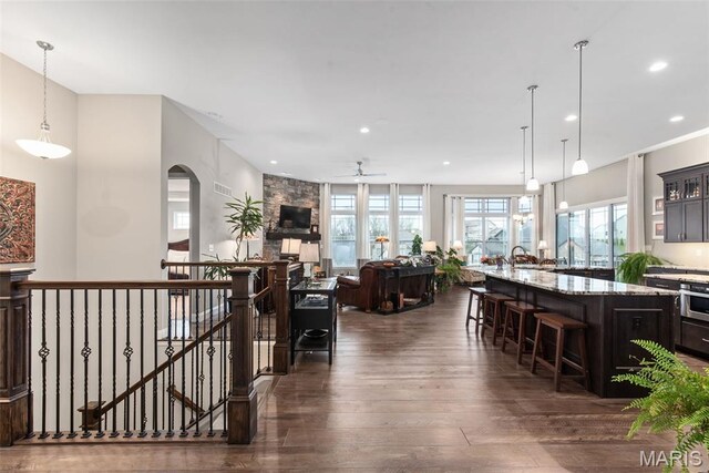 408 Hamlet Ct, Lake St Louis, MO 63367 - kitchen with dark wood finished floors, a breakfast bar, ceiling fan, light stone counters, and recessed lighting