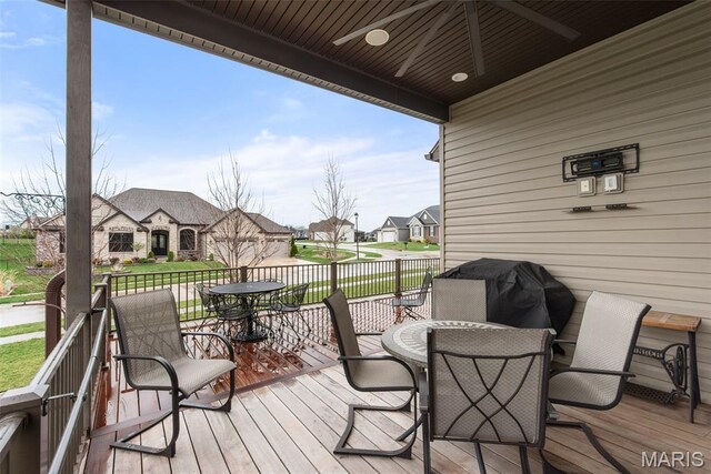 408 Hamlet Ct, Lake St Louis, MO 63367 - wooden deck with outdoor dining area, a residential view, and a grill