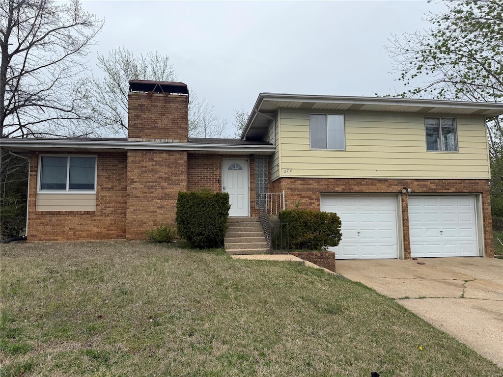 272 Vickie Lynn Ln, Saint Robert, MO 65584 - tri-level home with brick siding, an attached garage, a chimney, concrete driveway, and a front yard