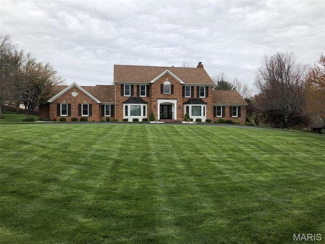 37 Lake Top Ct, Saint Charles, MO 63301 - view of front of property featuring a front lawn, a chimney, and brick siding