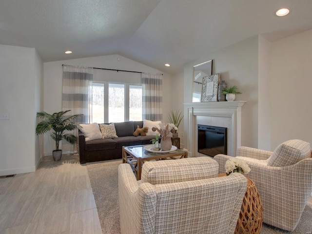 504 Timber View Ter, Hannibal, MO 63401 - living area with vaulted ceiling, a tiled fireplace, recessed lighting, and baseboards