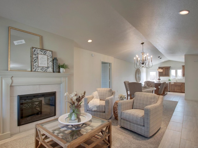 504 Timber View Ter, Hannibal, MO 63401 - living room featuring lofted ceiling, a chandelier, a glass covered fireplace, a textured ceiling, and recessed lighting