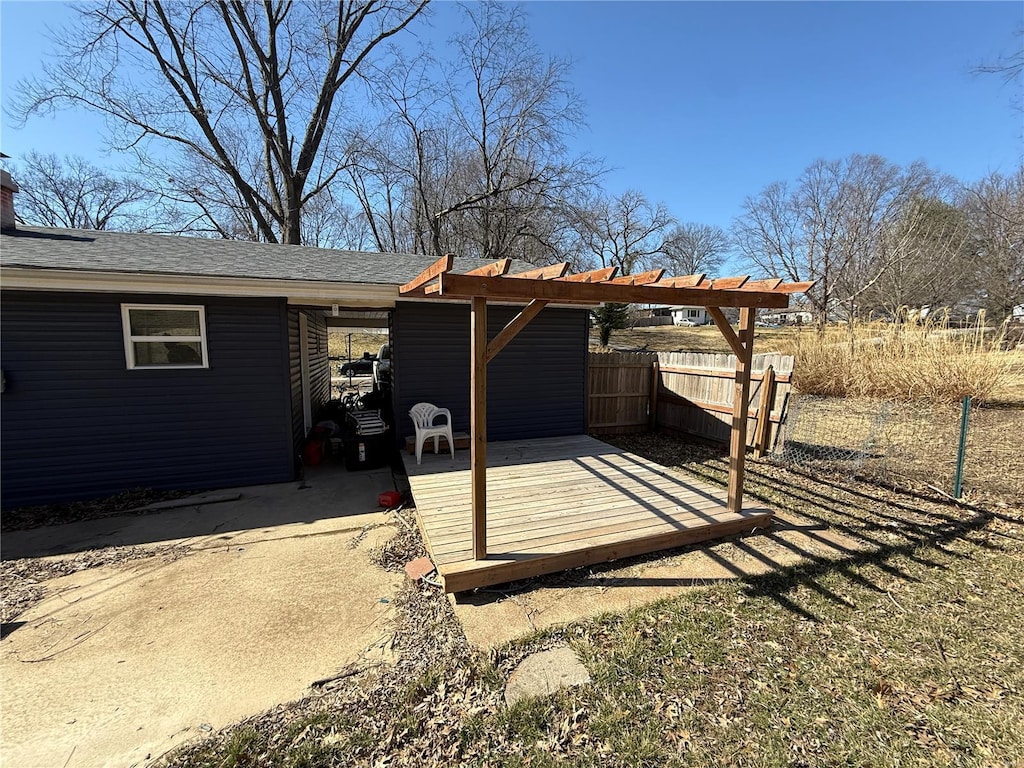 wooden terrace featuring fence