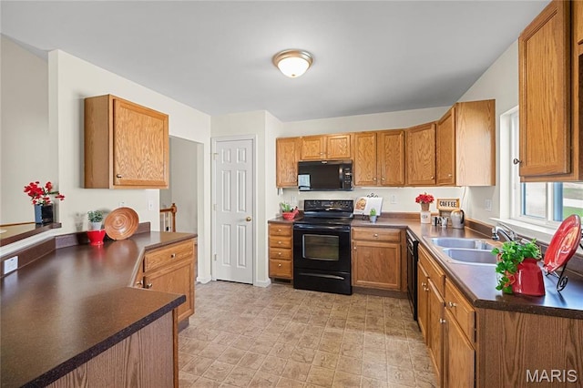 918 Fairway Dr, Union, MO 63084 - kitchen with black appliances, dark countertops, a sink, and brown cabinetry