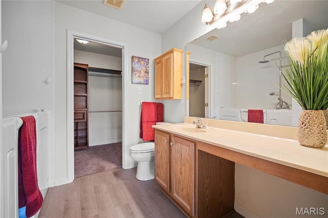 918 Fairway Dr, Union, MO 63084 - full bath featuring wood finished floors, vanity, toilet, baseboards, and a walk in closet