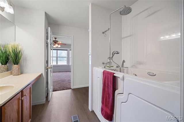918 Fairway Dr, Union, MO 63084 - full bathroom featuring vanity, wood finished floors, a ceiling fan, baseboards, and shower / washtub combination
