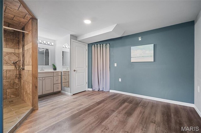 918 Fairway Dr, Union, MO 63084 - unfurnished bedroom with a sink, light wood-style flooring, baseboards, and connected bathroom