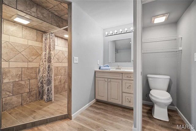 918 Fairway Dr, Union, MO 63084 - bathroom featuring toilet, a tile shower, vanity, and wood finished floors