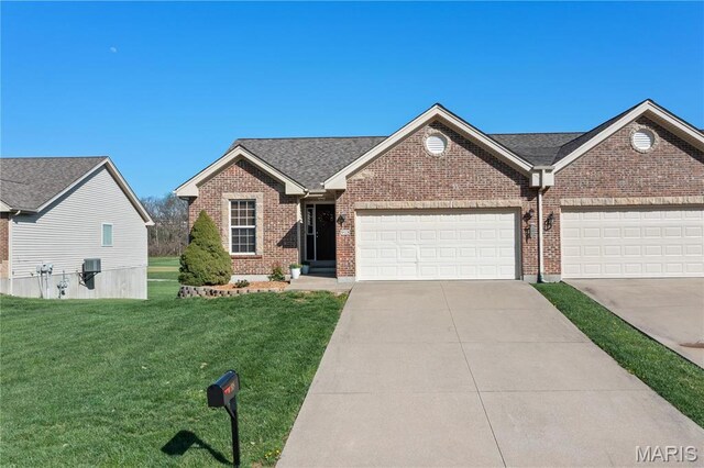 918 Fairway Dr, Union, MO 63084 - view of front of home featuring brick siding, a front yard, concrete driveway, and an attached garage