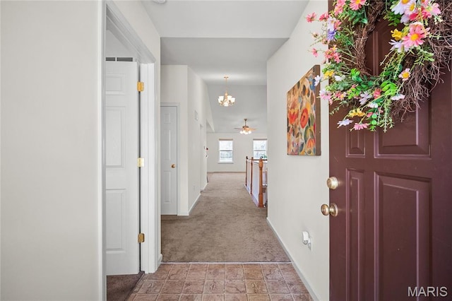 918 Fairway Dr, Union, MO 63084 - corridor featuring a chandelier, light carpet, baseboards, and light stone finish floors