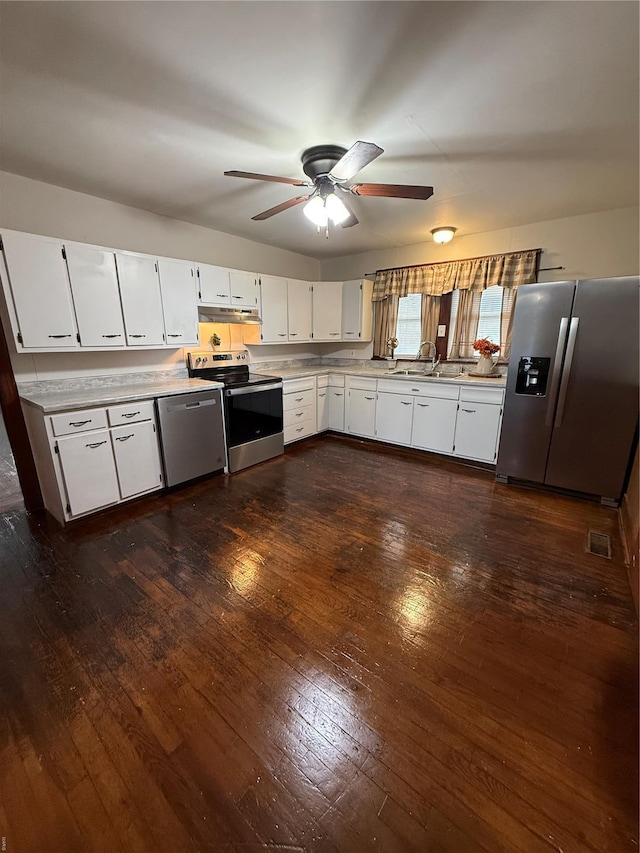 13978 Pike 496, Bowling Green, MO 63334 - kitchen featuring appliances with stainless steel finishes, light countertops, dark wood-type flooring, ceiling fan, and white cabinetry