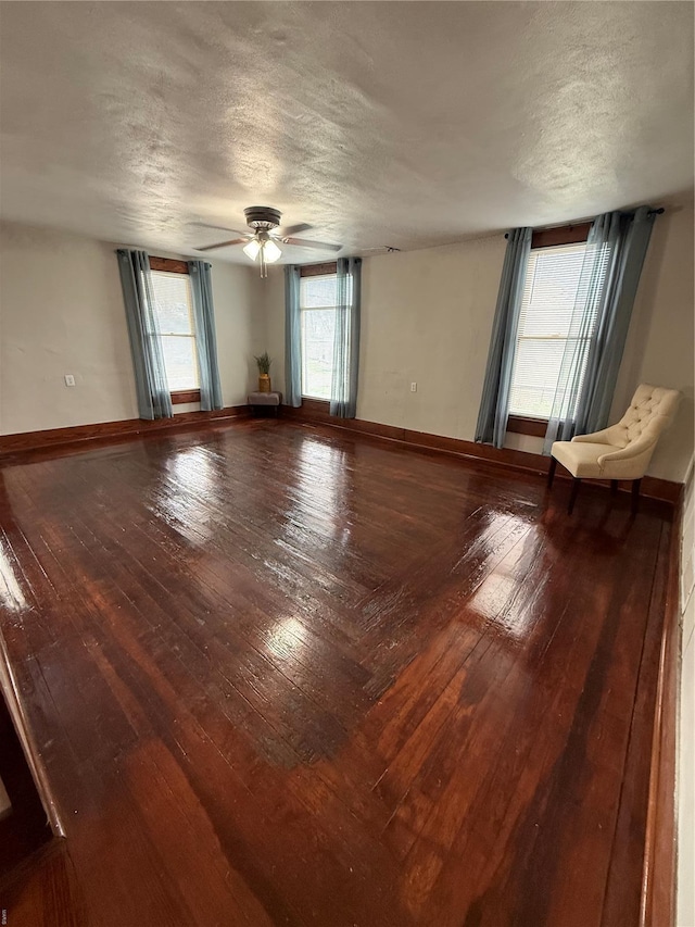 13978 Pike 496, Bowling Green, MO 63334 - unfurnished room with a textured ceiling, hardwood / wood-style floors, a ceiling fan, and baseboards