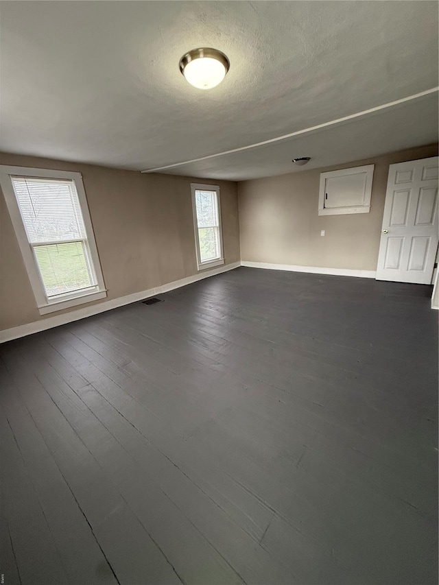 13978 Pike 496, Bowling Green, MO 63334 - unfurnished room with baseboards, dark wood-style flooring, and a textured ceiling