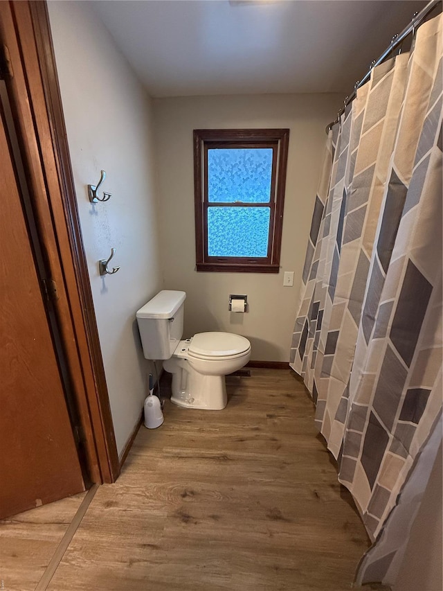 13978 Pike 496, Bowling Green, MO 63334 - full bath featuring toilet, wood finished floors, baseboards, and curtained shower