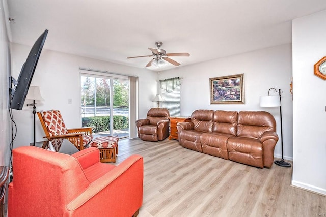 living room featuring a ceiling fan and wood finished floors