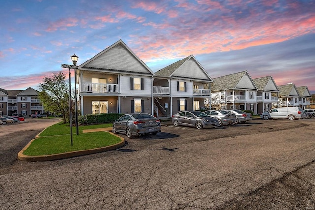 view of front facade with uncovered parking and a residential view
