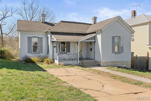 104 S 4th St, De Soto, MO 63020 - traditional-style house featuring covered porch, brick siding, and a chimney
