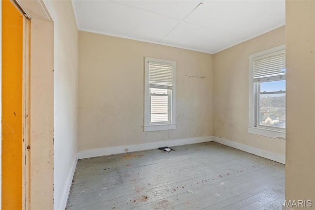 104 S 4th St, De Soto, MO 63020 - unfurnished room featuring plenty of natural light, hardwood / wood-style floors, and ornamental molding