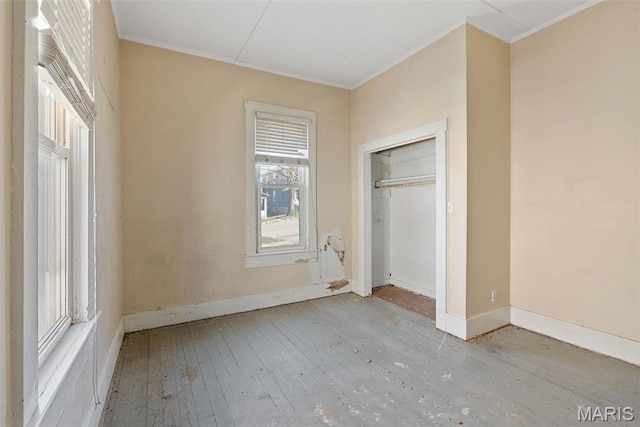 104 S 4th St, De Soto, MO 63020 - unfurnished bedroom with ornamental molding, hardwood / wood-style flooring, and a closet