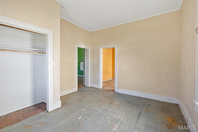 104 S 4th St, De Soto, MO 63020 - unfurnished bedroom with ornamental molding, hardwood / wood-style floors, and a closet