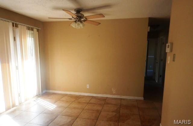 6530 Farm Pond Ct, Florissant, MO 63033 - tiled spare room with healthy amount of natural light, ceiling fan, and baseboards