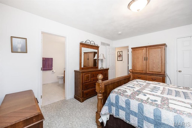 bedroom with light carpet and ensuite bath