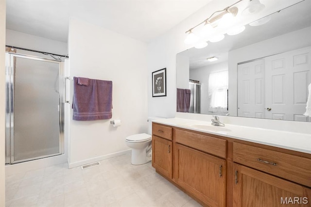 bathroom with a shower stall, baseboards, and vanity