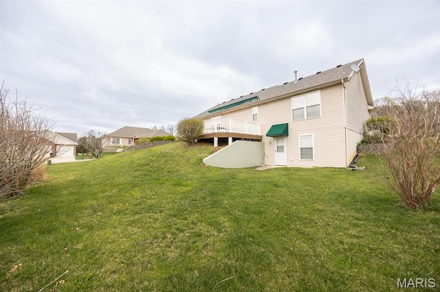 rear view of house featuring a lawn