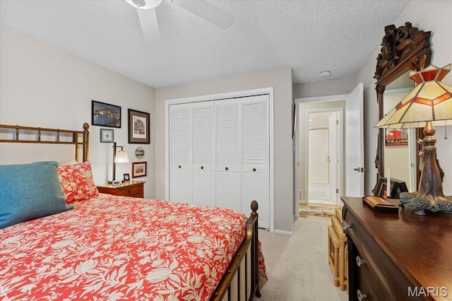 10358 Chimney Rock Dr Unit 2, Saint Louis, MO 63146 - bedroom with light colored carpet, a textured ceiling, a closet, ceiling fan, and baseboards