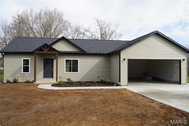 ranch-style house with a garage, driveway, and roof with shingles