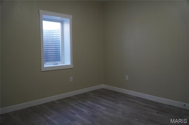 unfurnished room featuring dark wood finished floors and baseboards