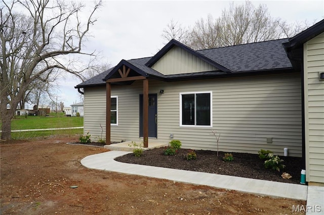 view of front of property with board and batten siding and a shingled roof