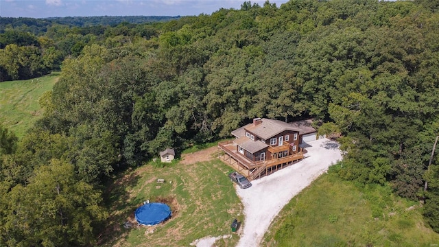 aerial view of property and surrounding area with a forest