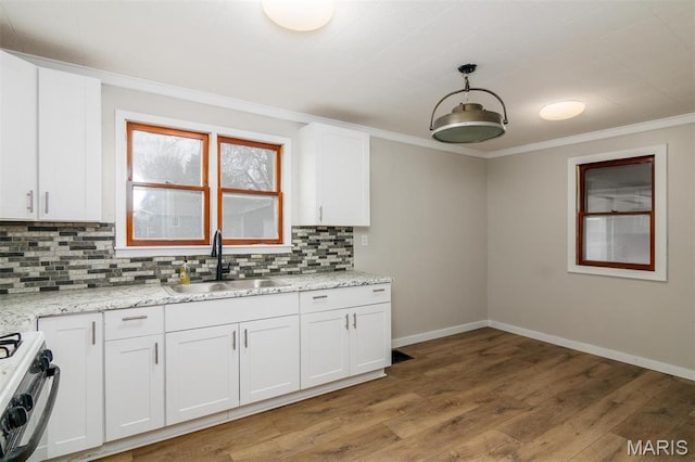 800 Frey St, Gillespie, IL 62033 - kitchen featuring a sink, baseboards, gas stove, ornamental molding, and white cabinetry
