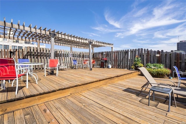 wooden terrace featuring a pergola and fence
