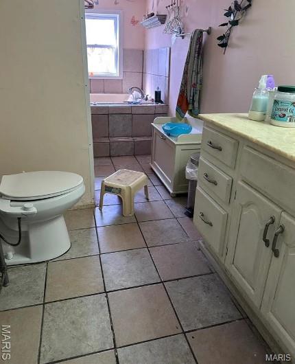 2108 Chippewa St, Saint Louis, MO 63118 - bathroom featuring toilet, a garden tub, and tile patterned flooring