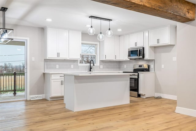 1121 E Cap Au Gris St, Troy, MO 63379 - kitchen featuring appliances with stainless steel finishes, baseboards, white cabinets, and recessed lighting
