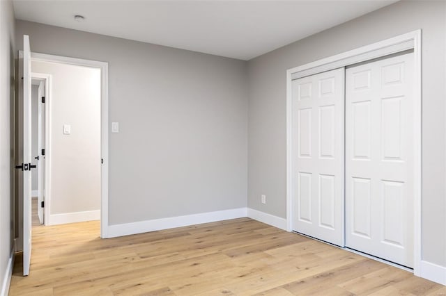 1121 E Cap Au Gris St, Troy, MO 63379 - unfurnished bedroom featuring baseboards, light wood finished floors, and a closet